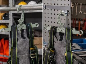 Heavy duty clothes hangers with folding design holding work vest and safety gear in a workshop